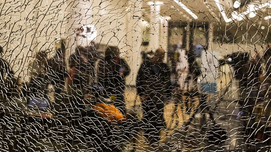 TEL AVIV, ISRAEL - JANUARY 09: Members of the press are seen through a cracked window while waiting for an update on Former PM Ariel Sharon's condition at the Tel Hashomer hospital on January 9, 2014 near Tel Aviv, Israel. according to Prof. Zeev Rotstein the director general of the Tel Hashomer hospital PM Ariel Sharon's condition is critical and he is suffering from a multiple organ failure,Sharon, 85, is hospitalised in Tel Hashomer hospital near Tel Aviv, and has been comatose since January 4, 2006 whe