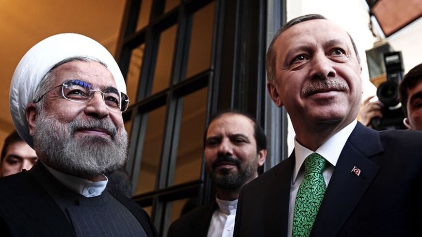 Iranian President Hassan Rouhani (L) greets Turkish Prime Minister Recep Tayyip Erdogan (R) at Tehran's Saadabad palace on January 29, 2014. Erdogan's visit comes as the two countries are trying to rebuild relations strained by the situation in Syria, with Iran supporting President Bashar al-Assad while Turkey backs the rebels seeking to oust him. AFP PHOTO/BEHROUZ MEHRI (Photo credit should read BEHROUZ MEHRI/AFP/Getty Images)