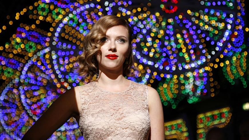 Actress Scarlett Johansson poses for photographers on the catwalk before the Dolce & Gabbana Spring/Summer 2012 women's collection during Milan Fashion Week September 25, 2011. REUTERS/Alessandro Garofalo (ITALY - Tags: FASHION ENTERTAINMENT) - RTR2RTN6