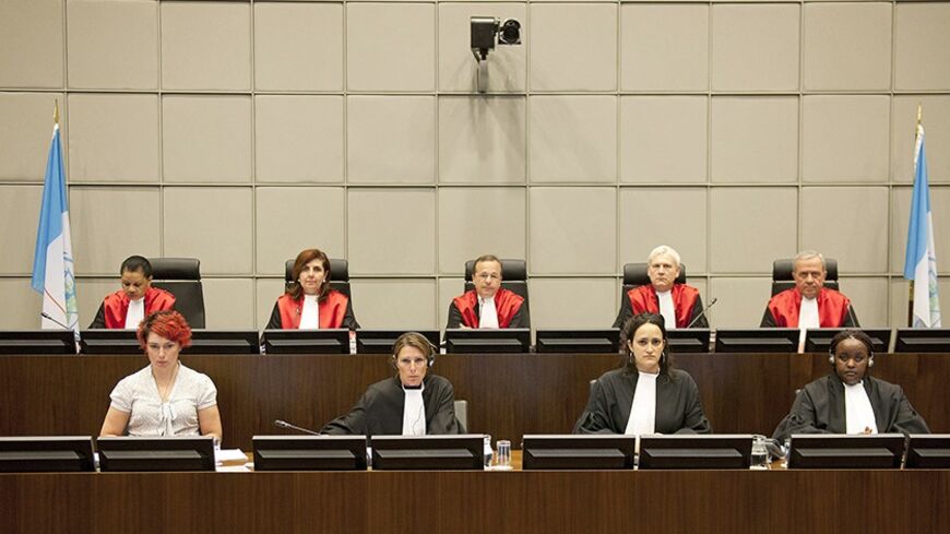 Judges of the U.N. Special Tribunal for Lebanon (STL) (back row, L to R) Janet Nosworthy, Micheline Braidi, Robert Roth, David Re and Walid Akoum attend the opening of the public hearing at the court in Leidschendam, near The Hague June 13, 2012. The Lebanon tribunal held the hearing to decide whether it has jurisdiction to try those responsible for the assassination of Lebanese prime minister in 2005. The defence teams of the four suspects challenged the legality of the tribunal. REUTERS/Robert Vos/Pool (N