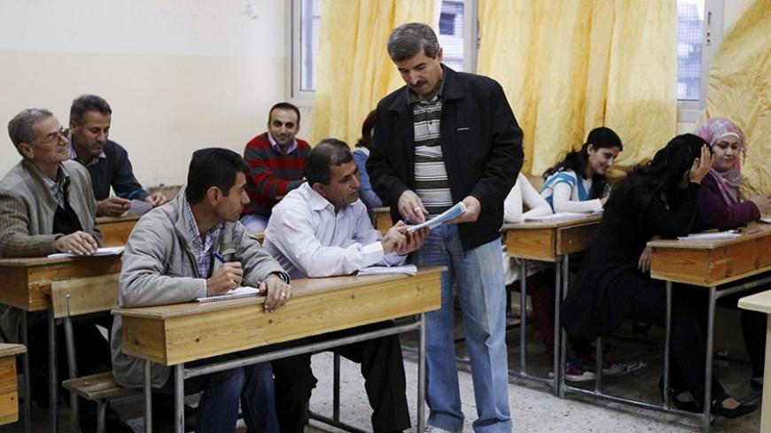 Syrian Kurds practise reading the Kurdish language at a school in Derik, Al-Hasakah October 31, 2012. Iraqi Kurdish President Masoud Barzani warned Kurds in Syria against being sucked into the "fires of discord," urging them to preserve Kurdish unity as tensions between rival factions threaten to spillover into violence. Syria's Kurds see the war ravaging their country as an unprecedented opportunity to gain the kind of freedoms enjoyed by their ethnic kin in neighbouring Iraq, where they live autonomously 