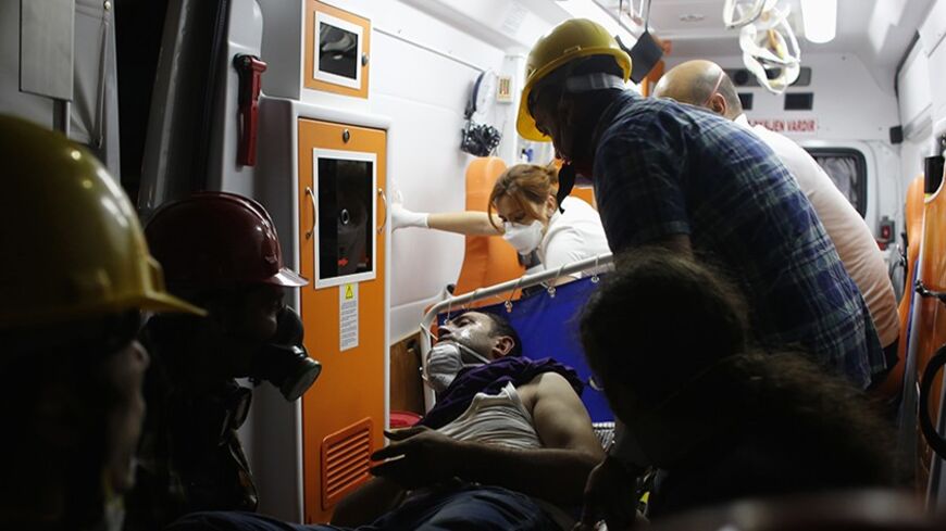 An injured protester is carried to an ambulance outside of Gezi Park in central Istanbul June 15, 2013. Thousands of people took to the streets of Istanbul overnight on Sunday, erecting barricades and starting bonfires, after riot police firing teargas and water cannon stormed a park at the centre of two weeks of anti-government unrest. Lines of police backed by armoured vehicles sealed off Taksim Square in the centre of the city as officers raided the adjoining Gezi Park late on Saturday, where protesters 