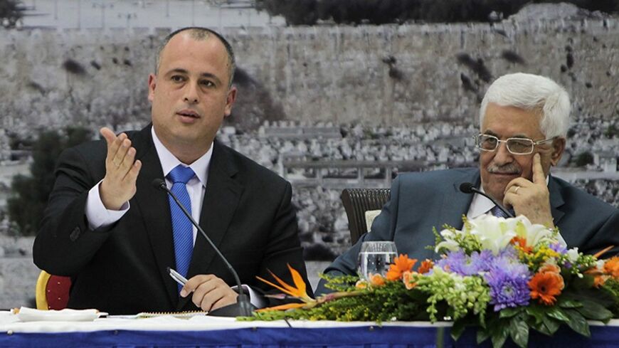 Israeli parliament member Hilik Bar (L) gestures as he sits next to Palestinian President Mahmoud Abbas during a meeting in the West Bank city of Ramallah October 7, 2013. Abbas held a rare meeting with the group of Israeli parliamentarians on Monday, warning that this could be the last chance to reach a deal to end decades of Israeli-Palestinian conflict and create two independent states living side-by-side.  REUTERS/Abbas Momani/Pool (WEST BANK - Tags: POLITICS) - RTX142QN