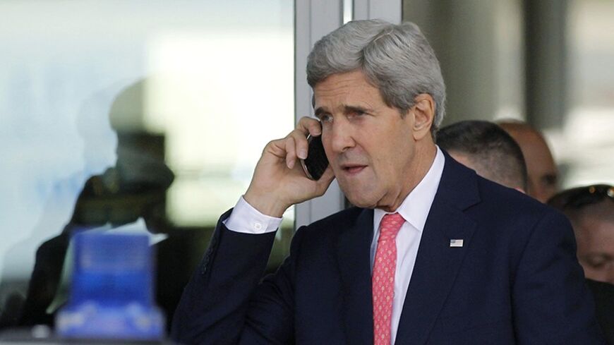 U.S. Secretary of State John Kerry speaks on a mobile phone after his private meeting with Israeli Prime Minister Benjamin Netanyahu in Tel Aviv November 8, 2013. REUTERS/Jason Reed (ISRAEL - Tags: POLITICS) - RTX1553L