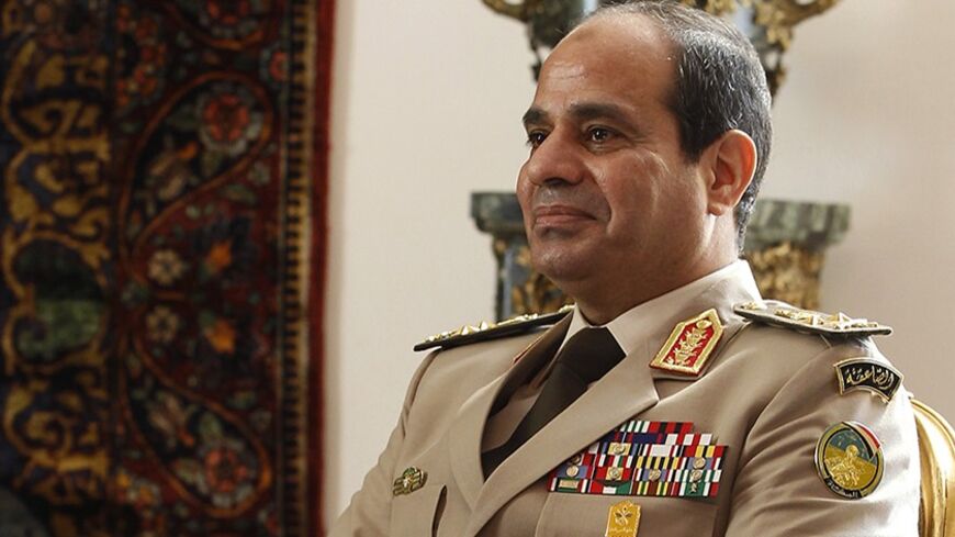 Egypt's Army Chief General Abdel Fattah al-Sisi attends a meeting with Egypt's interim President Adly Mansour, Russia's Defence Minister Sergei Shoigu and Foreign Minister Sergei Lavrov (not pictured) at El-Thadiya presidential palace in Cairo, November 14, 2013. Sisi hailed a new era of defense cooperation with Russia on Thursday during a visit by Russian officials, signaling Egyptian efforts to revive ties with an old ally and send a message to Washington after it suspended military aid. REUTERS/Amr Abdal