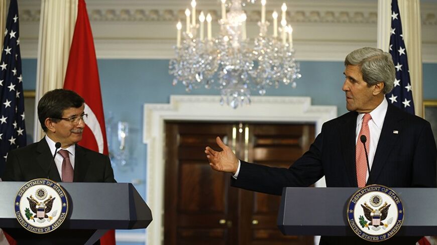 U.S. Secretary of State John Kerry and Turkish Foreign Minister Ahmet Davutoglu (L) speak to reporters at the State Department in Washington November 18, 2013. 
REUTERS/Kevin Lamarque  (UNITED STATES - Tags: POLITICS) - RTX15J4I