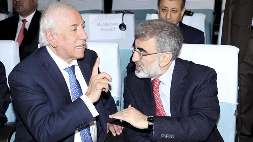 Turkey's Energy Minister Taner Yildiz (R) speaks with Iraqi Kurdish Regional Government Natural Resources Minister Ashti Hawrami (L) at the Iraq-Kurdistan Oil and Gas Conference at Arbil in Iraq's Kurdistan region, December 2, 2013. Turkey said on Monday it stood by a bilateral oil deal with Iraq's Kurdistan region that bypassed central government but wanted to win Baghdad's support by drawing it into the arrangement. Reuters reported that Turkey and Iraqi Kurdistan signed a multi-billion-dollar energy pack
