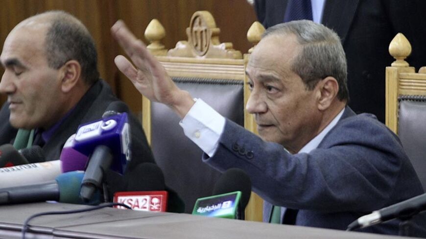 Judge Moustafa Mohammed Salama gestures while speaking during the trial of Muslim Brotherhood leaders in a courtroom in Cairo December 11, 2013. Prominent members of the Brotherhood were arrested in a state crackdown on the group following the army overthrow of President Mohamed Mursi and are charged with perpetrating violence during July's clashes.  REUTERS/Stringer (EGYPT - Tags: POLITICS CRIME LAW) - RTX16DUD
