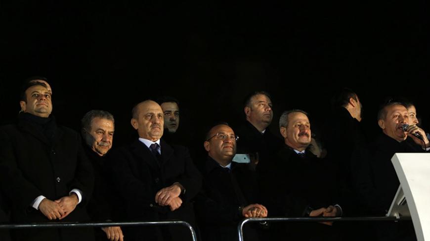 (From L to R) Turkey's European Affairs Minister Egemen Bagis, Interior Minister Muammer Guler, Environment and City Planning Minister Erdogan Bayraktar, Deputy Prime Minister Bekir Bozdag and Economy Minister Zafer Caglayan listen as Prime Minister Tayyip Erdogan addresses his supporters at Esenboga Airport in Ankara December 24, 2013. Turkish ministers Caglayan and Guler resigned on Wednesday after their sons were arrested in a corruption investigation that has pitted the government against the judiciary