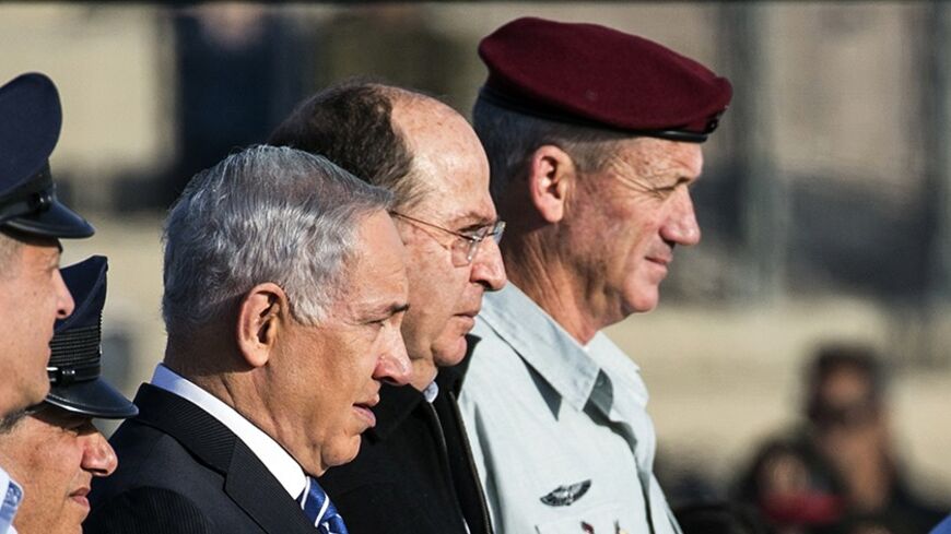 Israeli Prime Minister Benjamin Netanyahu (C) stands next to Defence Minister Moshe Ya'alon (2nd R) and Chief of the General Staff Lieutenant General Benny Gantz (R) during an air force pilots' graduation ceremony at Hatzerim air base in southern Israel December 26, 2013. REUTERS/Nir Elias (ISRAEL - Tags: MILITARY POLITICS) - RTX16UGX