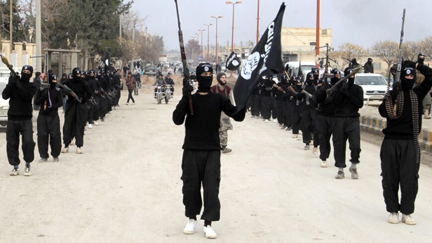 Fighters of al-Qaeda linked Islamic State of Iraq and the Levant carry their weapons during a parade at the Syrian town of Tel Abyad, near the border with Turkey January 2, 2014. Picture taken January 2, 2014. REUTERS/Yaser Al-Khodor (SYRIA - Tags: POLITICS CIVIL UNREST CONFLICT) - RTX170UI