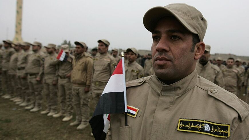 Iraqi volunteers take part in a parade in Karbala, 110 km (68 miles) south of Baghdad, January 11, 2014. About 2,000 fighters volunteered from the provinces of central and south of Iraq to support tribal fighters and Iraqi security forces fighting the Islamic State in Iraq and the Levant (ISIL) at the desert in Anbar province.    REUTERS/Mushtaq Muhammed     (IRAQ - Tags: CIVIL UNREST POLITICS CONFLICT) - RTX179JO