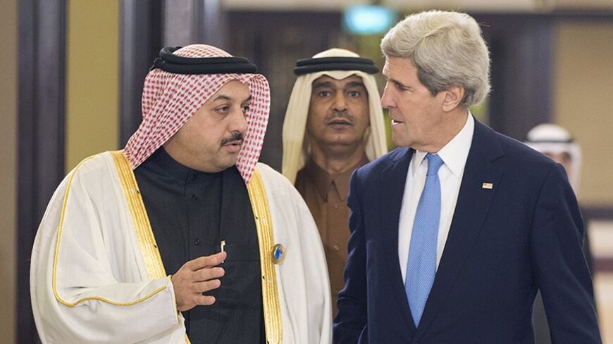 U.S. Secretary of State John Kerry speaks with Qatar's Foreign Minister Khalid al-Attiyah (L) before the opening session of the Syrian Donors Conference at Bayan Palace in Kuwait City January 15, 2014. Kuwait's emir Sheikh Sabah al-Ahmed al-Sabah promised $500 million on Wednesday for U.N. humanitarian efforts in Syria, devastated by almost three years of civil war. The emir made the pledge at an international donor conference intended to help the world body reach a $6.5 billion aid target for the crisis in