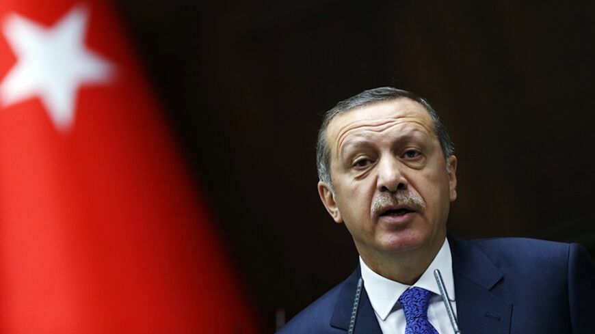 Turkey's Prime Minister Tayyip Erdogan addresses members of parliament from his ruling AK Party (AKP) during a meeting at the Turkish parliament in Ankara January 28, 2014. Erdogan, keen to maintain economic growth ahead of an election cycle starting in two months, has been a vociferous opponent of the higher borrowing costs sometimes needed to bolster currencies, railing against what he describes as an 'interest rate lobby' of speculators seeking to stifle growth and undermine the economy. REUTERS/Umit Bek