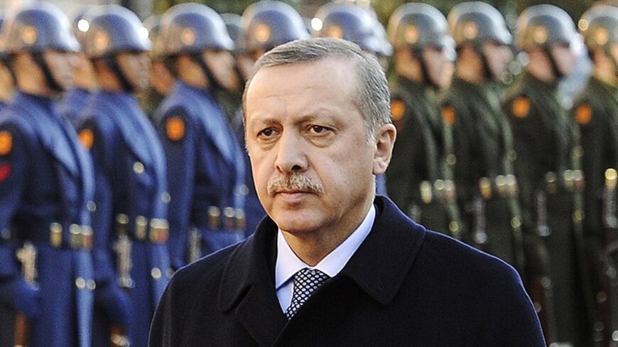 Turkey's Prime Minister Tayyip Erdogan, with a military guard of honour in the background, welcomes Crown Prince of Bahrain Sheikh Salman bin Hamad al-Khalifa before their meeting in Ankara February 8, 2011.  REUTERS/Stringer (TURKEY - Tags: POLITICS ROYALS) - RTXXLWB