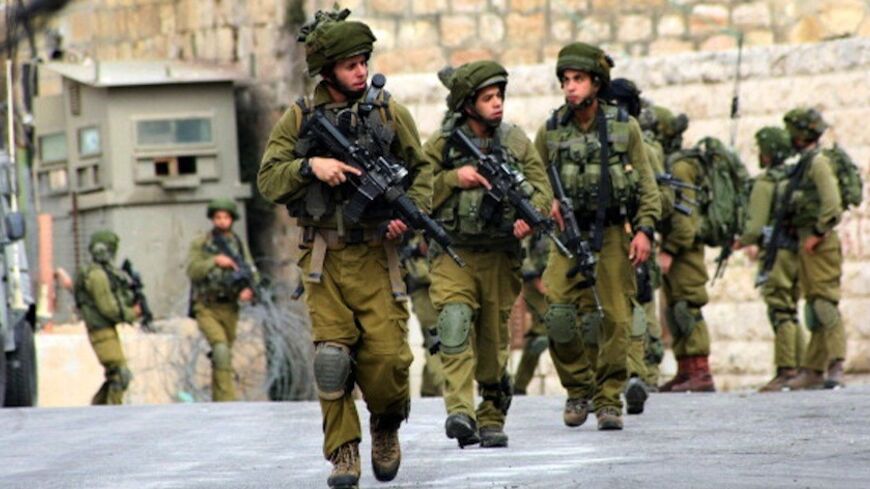 HEBRON, WEST BANK, PALESTINIAN TERRITORY, SEPTEMBER 23: Israeli soldiers on patrol on September 23, 2013 in the West Bank city of Hebron. Unknown gunmen shot and killed an Israeli soldier in the city of Al-Khalil (Hebron) in the occupied West Bank on Sunday and troops are searching for the shooter, the military said. (Photo by Mamoun Wazwaz/Anadolu Agency/Getty Images)