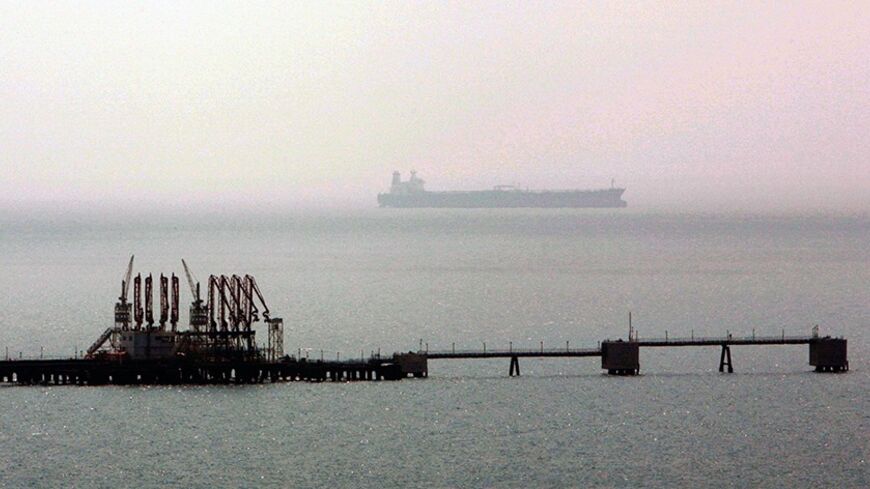 A tanker sails in Mediterranean past a jetty at the Ceyhan crude oil terminal near Turkey's southern coastal city of Adana, July 13, 2006. A four-billion dollar project, Baku-Tblisi-Ceyhan crude oil pipeline, to carry oil from the Caspian Sea fields to western markets is inaugurated on Thursday in Ceyhan, southern Turkey. REUTERS/Fatih Saribas (TURKEY) - RTR1FGD4