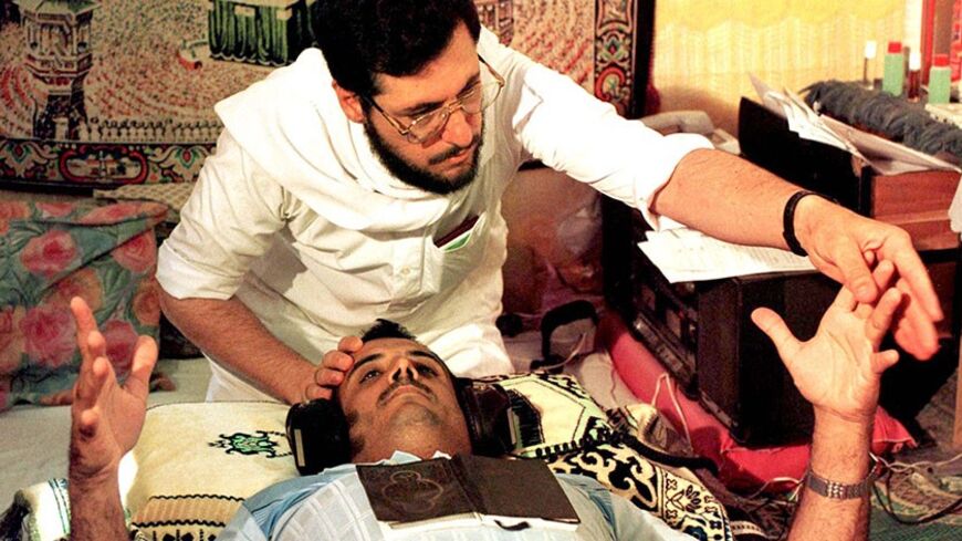 FOR RELEASE WITH FEATURE BC-PALESTINIAN-EXORCISM - Ziad al-Tatar, a 38-year-old Palestinian exorcist, uses a Koran placed on a man's chest and readings from the Koran piped through earphones and honey to exorcise a demon from a patient. In his spartan clinic, adorned with framed Koranic verses, Tatar admits to a steady stream of patients stricken with ailments ranging from impotence to infiltration by devils known in Arabic as Djinn.

DPS/KM - RTRFVSJ