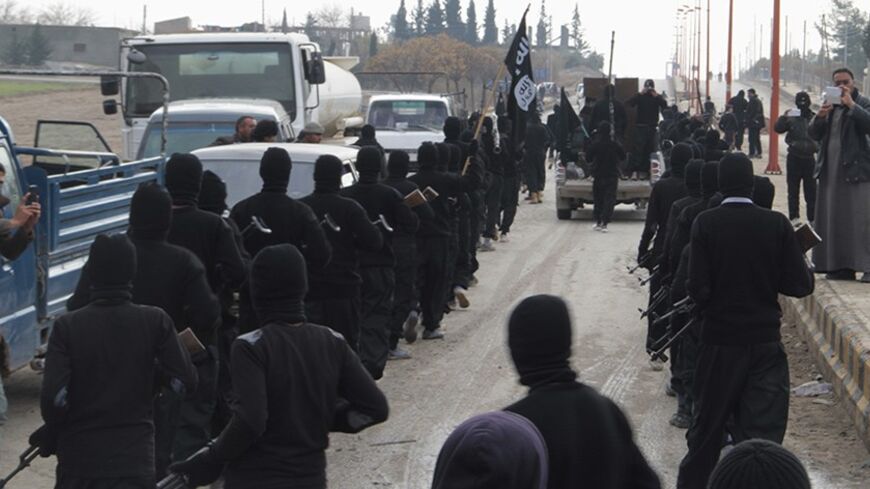 Fighters of al-Qaeda linked Islamic State of Iraq and the Levant parade at the Syrian town of Tel Abyad, near the border with Turkey January 2, 2014. Picture taken January 2, 2014.  REUTERS/Yaser Al-Khodor (SYRIA - Tags: POLITICS CIVIL UNREST CONFLICT) - RTX170UO