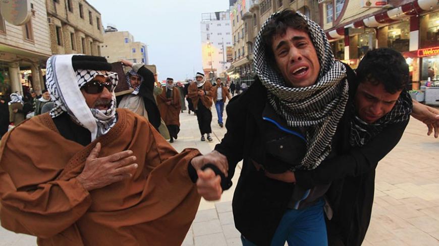 Mourners react during a funeral of an Iraqi soldier, who was killed during clashes in Ramadi, in Najaf, 160 km (99 miles) south of Baghdad, January 10, 2014. Militants of the al Qaeda-linked Islamic State of Iraq and the Levant (ISIL), which is also fighting in neighbouring Syria, took control of Falluja and parts of nearby Ramadi on January 1 with the help of sympathetic armed tribesmen. The prospect of an imminent Iraqi army assault on Falluja receded on Friday as negotiators tried to work out a deal unde