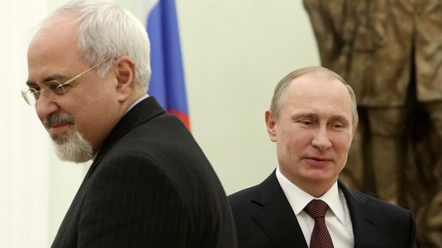 Russian President Vladimir Putin (R) passes Iran's Foreign Minister Mohammad Javad Zarif during their meeting in Moscow's Kremlin January 16, 2014. REUTERS/Sergei Karpukhin (RUSSIA - Tags: POLITICS) - RTX17GFG
