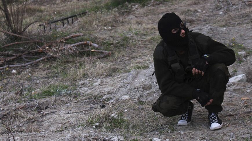 A Free Syrian Army fighter rests while training in the Jabal al-Akrad area in Syria's northwestern Latakia province January 20, 2014. Picture taken January 20, 2014. REUTERS/Khattab Abdulaa (SYRIA - Tags: POLITICS CIVIL UNREST CONFLICT) - RTX17O88
