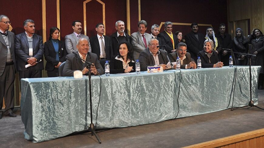 Members of the interim government of democratic self-administered party stand after declaring a provincial government, in the city of Amuda near Hasaka January 21, 2014.  Kurds in Syria declared a provincial government in the north of the country on Tuesday, consolidating their geographic and political presence on the eve of peace talks in Switzerland at which they will not be represented. The municipal council will run affairs in one of three administrative districts set up by Kurds, who have seized upon t