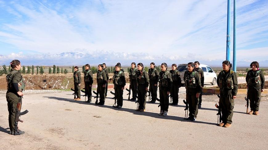 Kurdish female fighters of the Kurdish People's Protection Units (YPJ) are seen in training at a military camp in Malikiya, Hassaka province December 9, 2013. Picture taken December 9, 2013.    REUTERS/Rodi Said (SYRIA - Tags: CIVIL UNREST CONFLICT) - RTX17Q2P