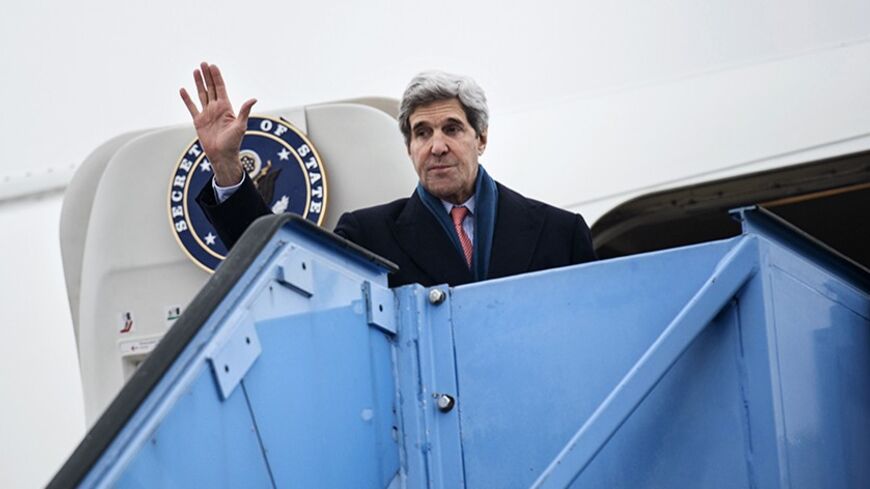 U.S. Secretary of State John Kerry waves while boarding his plane at Franz-Josef-Strauss Airport in Munich, southern Germany, February 2, 2014. Kerry was in the Bavarian capital to attend the Munich Security Conference. REUTERS/Brendan Smialowski/Pool (GERMANY - Tags: POLITICS) - RTX184TL