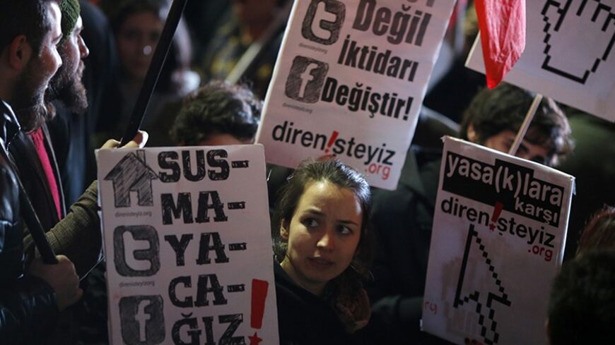 Protesters shout slogans, hold banners and wave flags as they demonstrate against new controls on the Internet approved by Turkish parliament this week in Ankara February 8, 2014. The new powers, once approved by the president, will let authorities block web pages within hours, in what the opposition has said is part of a government bid to stifle a corruption scandal. The signs read "We won't become silent. Change the government not the DNS". REUTERS/Umit Bektas (TURKEY - Tags: POLITICS CIVIL UNREST CRIME L