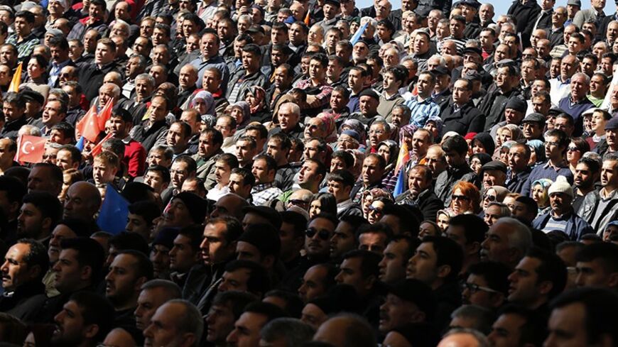 Supporters of Turkish Prime Minister Tayyip Erdogan listen to his speech during the opening ceremony of a new line of the Ankara Metro in Ankara February 12, 2014. REUTERS/Umit Bektas (TURKEY - Tags: POLITICS) - RTX18NXK