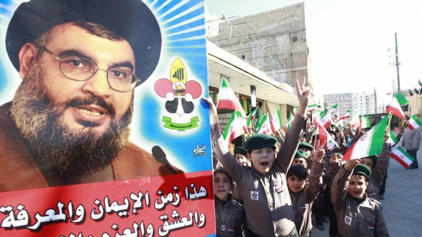 Syrian children chant anti- Free Syrian Army slogans as their hold posters of Hezbollah leader Sayyed Hassan Nasrallah and Iranian flags at the Sayeda Zainab area in Damascus, February 10, 2014.   Picture taken February 10, 2014.  REUTERS/Alaa Al-Marjani (SYRIA - Tags: CIVIL UNREST POLITICS CONFLICT) - RTX18VH0