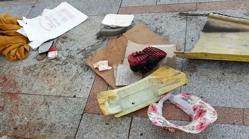 A shoe is seen on a pavement covered with blood in the Red Sea resort town of Taba in the south Sinai, February 16, 2014. An explosion on a  tourist bus in Egypt's Sinai peninsula killed three Koreans and the Egyptian driver on Sunday, the Interior Ministry said, an apparent turning point in an  Islamist insurgency that has gained pace since an army takeover in July. REUTERS/Stringer (EGYPT - Tags: POLITICS CIVIL UNREST) - RTX18XQD