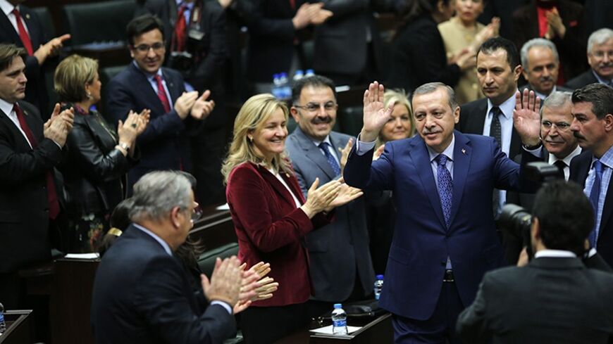 Turkey's Prime Minister Tayyip Erdogan greets his supporters as he arrives at a meeting at the Turkish parliament in Ankara February 18, 2014. REUTERS/Umit Bektas (TURKEY - Tags: POLITICS) - RTX1916P