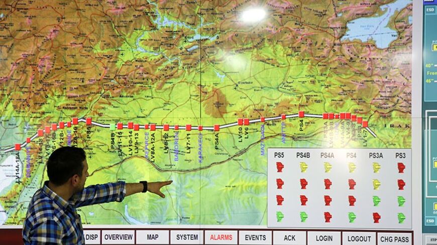 A staff member points at a screen showing a map of the Kirkuk-Ceyhan pipeline at Turkey's Mediterranean port of Ceyhan, which is run by state-owned Petroleum Pipeline Corporation (BOTAS), some 70 km (43.5 miles) from Adana February 19, 2014. Crude oil flow through the Kirkuk-Ceyhan pipeline linking Iraq to Turkey restarted on Wednesday at a rate of at a rate of about 300,000-350,000 barrels per day (bpd), a Turkish energy official said. The pipeline, which carries Kirkuk crude to Turkey's Mediterranean port