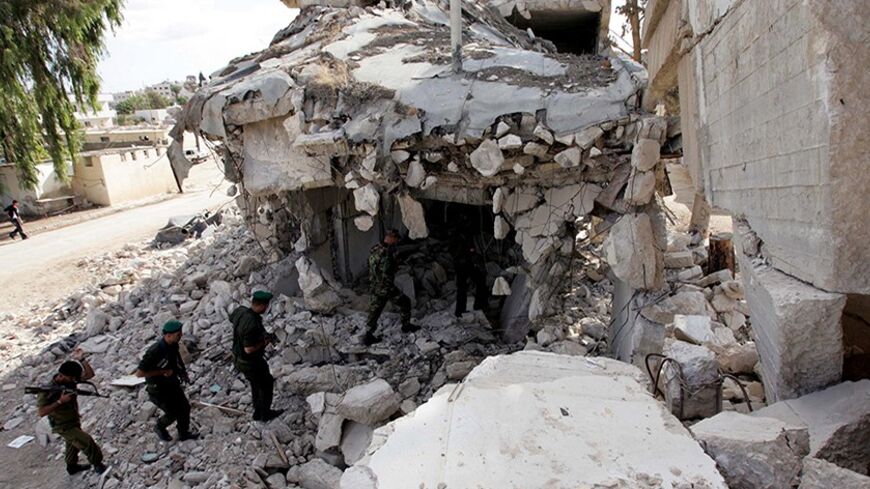 Members of the Palestinian security forces walk amid the ruins of the Muqata in the West Bank city of Jenin November 12, 2007. Palestinian Prime Minister Salam Fayyad's plan calls for rebuilding eight muqatas -- Arabic for headquarters -- and other administrative buildings flattened by Israel across the occupied West Bank after the start of a Palestinian uprising in 2000. Once seen by Palestinians as symbols of sovereignty, the ruins that remain have become permanent reminders of Israel's destructive power