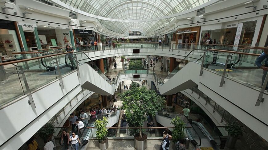 Shoppers walk in Istinye Park shopping mall in Istanbul May 17, 2013. Turkey hailed its second investment grade rating on Friday, seeing it as a seal of approval from international markets for a decade of economic reform. REUTERS/Osman Orsal (TURKEY - Tags: BUSINESS) - RTXZQ6S