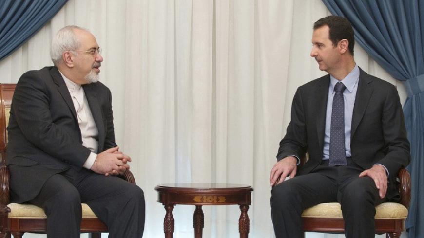 Syria's President Bashar al-Assad (R) meets Iran's Foreign Minister Mohammad Javad Zarif in Damascus January 15, 2014, in this handout released by Syria's national news agency SANA. REUTERS/SANA/Handout via Reuters (SYRIA - Tags: POLITICS CONFLICT) ATTENTION EDITORS - THIS IMAGE WAS PROVIDED BY A THIRD PARTY. FOR EDITORIAL USE ONLY. NOT FOR SALE FOR MARKETING OR ADVERTISING CAMPAIGNS. THIS PICTURE IS DISTRIBUTED EXACTLY AS RECEIVED BY REUTERS, AS A SERVICE TO CLIENTS - RTX17F37