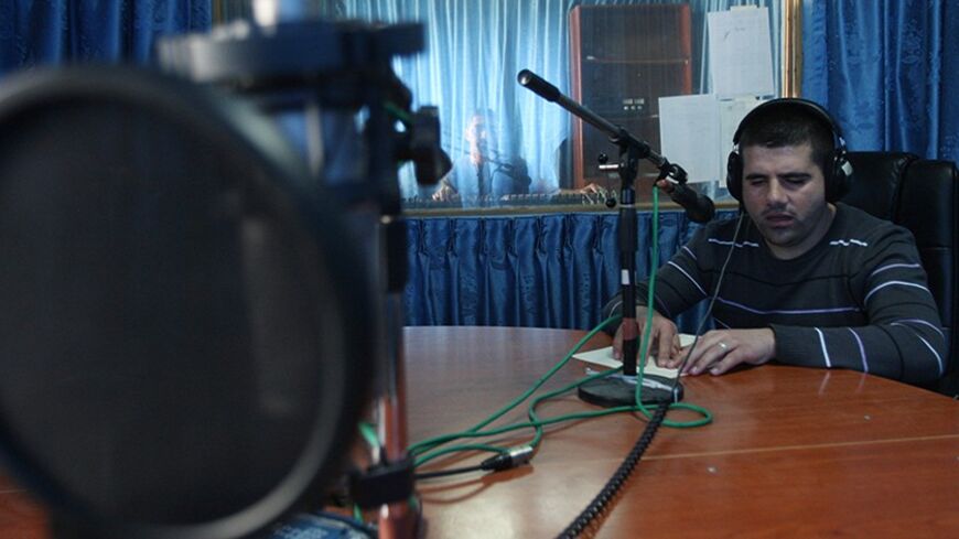 TO GO WITH AFP STORY BY HOSSAM EZZEDDINE
Mustafa Jawhari, a 20-year-old blind Palestinian university graduate with a specialisation in music, presents a radio program at radio station in the West Bank city of Ramallah on April 9, 2012. Jawhari's wish is to present a TV program following his success in radio. AFP PHOTO/ABBAS MOMANI (Photo credit should read ABBAS MOMANI/AFP/Getty Images)