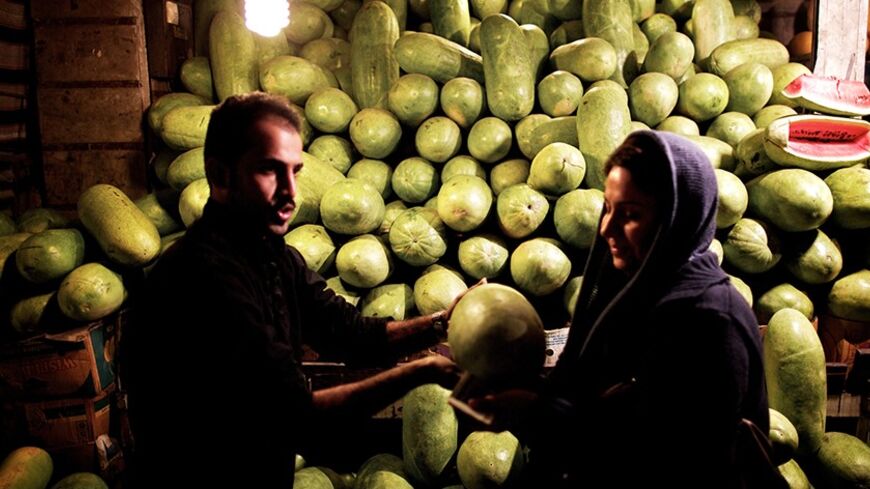 An Iranian woman buys a watermelon in downtown Tehran on December 21, 2013, in preparation for the annual festival of Yalda, an ancient Zoroastrian rite held on the longest night of the year or the beginning of winter. The rite, which marks the victory of Good over Evil, is still celebrated by most Iranians even though Islam replaced Zoroastrianism as the official religion in the seventh century. Iranians traditionally spend Yalda at home with their families, reciting poetry and feasting on fruits and nuts.