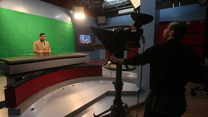 A Palestinian anchor works inside a studio of Al-Aqsa Television in Gaza City March 19, 2010. U.S. Treasury on Thursday imposed sanctions against two firms in Gaza Islamic National Bank and Al-Aqsa Television for their ties to Hamas. Mohammed Abu Thraya, deputy director of the Al-Aqsa station called on world media outlets to condemn what he called an assault by Israel and the U.S. against "free media". REUTERS/Suhaib Salem (GAZA - Tags: POLITICS CIVIL UNREST MEDIA) - RTR2BTGD