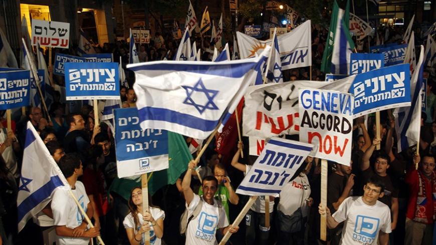 Left-wing Israeli activists take part in a rally in Jerusalem in this May 15, 2010 file photo. The weekend rally in Jerusalem by Israelis demanding an end to their country's settlement and occupation of the West Bank was hailed by its left-wing sponsors as the start of a major push that could help U.S. peace efforts. Photo taken May 15, 2010.   REUTERS/Ronen Zvulun/Files  (JERUSALEM - Tags: CIVIL UNREST POLITICS) - RTR2DYLU