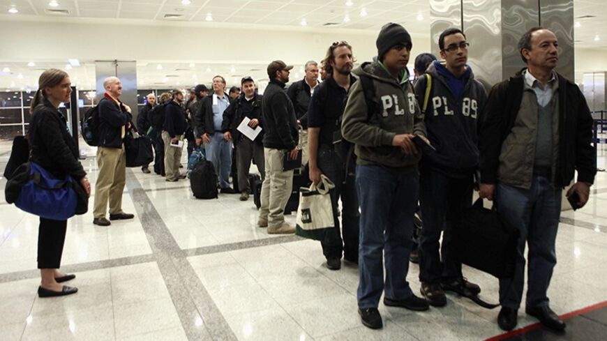U.S citizens returning from Libya arrive at Ataturk international airport in Istanbul February 25, 2011. The United States announced on Friday it would soon impose sanctions on Libya and bluntly said the legitimacy of longtime Libyan leader Muammar Gaddafi had been "reduced to zero." REUTERS/Osman Orsal (TURKEY - Tags: POLITICS) - RTR2J4AK