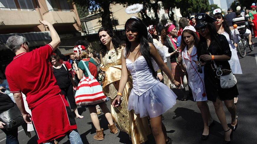 Students and visitors of the Bialik Rogozin school dress up as they take part in celebrations ahead of the Jewish holiday of Purim in south Tel Aviv March 18, 2011. The school, where children of migrant workers and refugees from 48 states learn alongside native Israelis, was recently featured in a short documentary which won an Oscar. Purim is a celebration of the Jews' salvation from genocide in ancient Persia, as recounted in the Book of Esther. REUTERS/Nir Elias (ISRAEL - Tags: RELIGION SOCIETY) - RTR2K1