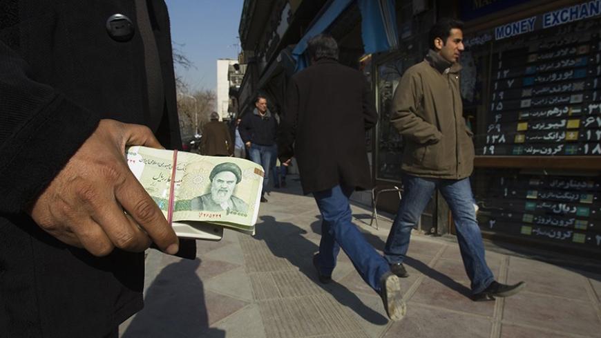 EDITORS' NOTE: Reuters and other foreign media are subject to Iranian restrictions on leaving the office to report, film or take pictures in Tehran.

A money changer holds Iranian rial banknotes as he waits for customers in Tehran's business district January 7, 2012. REUTERS/Raheb Homavandi  (IRAN - Tags: BUSINESS) - RTR2VZCL