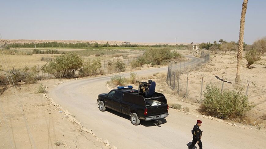 An Iraqi police vehicle patrols near the Iraqi-Syrian borders at the Abu Kamal-qaim border crossing, the main border post between Iraq and Syria, September 8, 2012. Al Qaim, in the Sunni heartland of Anbar province, reflects the tricky balancing act Iraq's Shi'ite leaders face in Syria, whose crisis is testing the Middle East's sectarian divide. Al Qaim and its neighbouring Syrian counterpart Albu Kamal are on a strategic supply route for smugglers, gun-runners and now insurgents aiming to join the rebellio