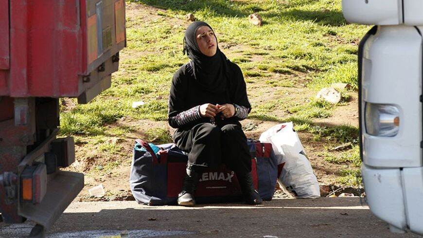 A Syrian woman waits for the opening of Cilvegozu border gate near the town of Reyhanli at the Turkish-Syrian border in Hatay province February 13, 2013. A Syrian minibus exploded at a crossing on Turkey's border with Syria near the Turkish town of Reyhanli on Monday, killing 14 people including Turkish citizens and wounding dozens more, Turkish officials said. REUTERS/Umit Bektas (TURKEY - Tags: POLITICS CIVIL UNREST TRANSPORT) - RTR3DQC1
