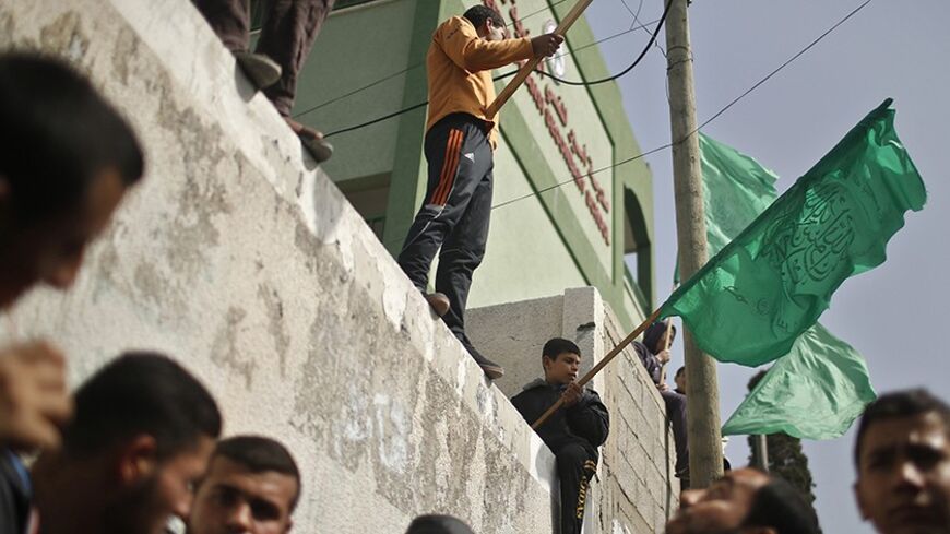 Palestinians Hamas supporters take part in a protest in front of the Egyptian embassy in Gaza March 7, 2014, against a recent rule by Egyptian court which banned all the activities of Hamas movement in Egypt. An Egyptian court on March 4, 2014 banned all activities of Hamas in Egypt in a further sign that Cairo's military-backed government aims to squeeze the Palestinian Islamist group that rules neighbouring Gaza, regarding it as a security threat. REUTERS/Mohammed Salem (GAZA - Tags: POLITICS CIVIL UNREST