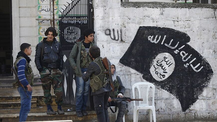 Free Syrian Army fighters stand at a former base used by fighters from the Islamic State in Iraq and the Levant (ISIL), after the ISIL withdrew from the town of Azaz, near the Syrian-Turkish border, March 11, 2014. Syrian refugees in this border outpost were delighted to hear their home town of Azaz had been liberated - not from Bashar al-Assad's troops but from al-Qaeda fighters who subjected them to a regime that included torture and public beheadings. For Syrians who three years ago rose up against 43 ye