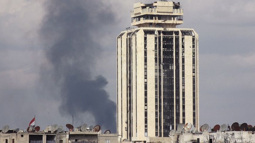 Smoke rises at the Karaj al-Hajez crossing, a passageway separating Aleppo's Bustan al-Qasr, which is under the rebels' control and Al-Masharqa neighbourhood, an area controlled by the regime March 13, 2014. REUTERS/Sultan Ketaz (SYRIA - Tags: POLITICS CIVIL UNREST CONFLICT) - RTR3GZNW